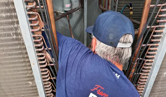 Maricopa Air technician servicing a commercial condenser coil