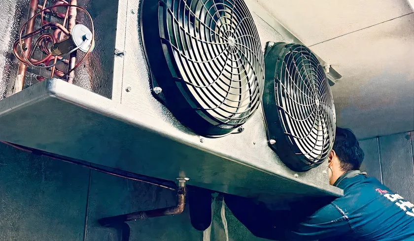 Maricopa Air technician repairing a walk-in cooler evaporator